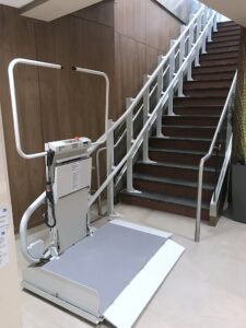 Commercial Wheelchair Lift at the bottom of a staircase in Lifetime Fitness