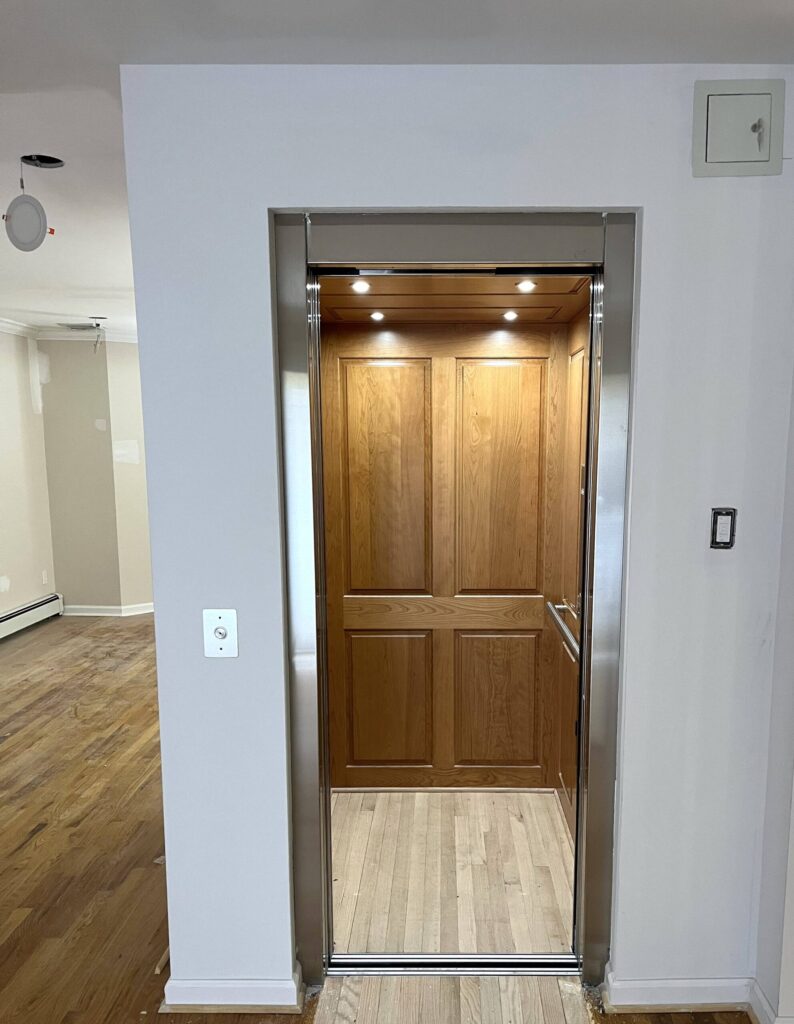 This residential elevator from Infinity features a fine cherry finish